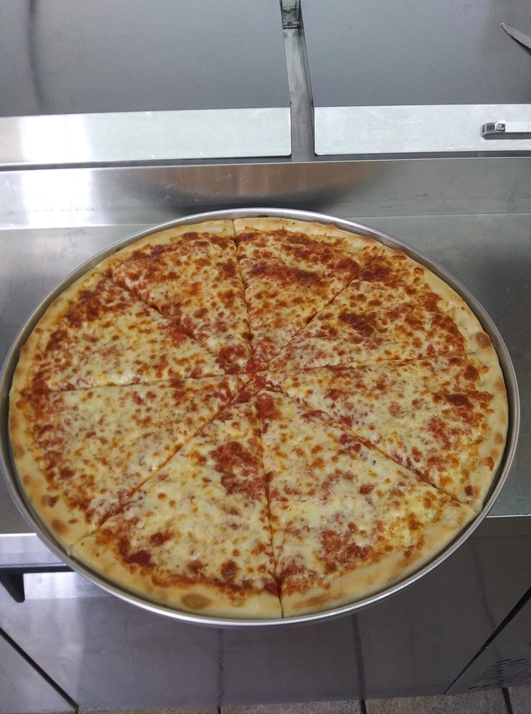 Fresh baked pizza in kitchen
